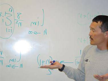 Professor Edward Bonan-Hamada explaining problem on whiteboard
